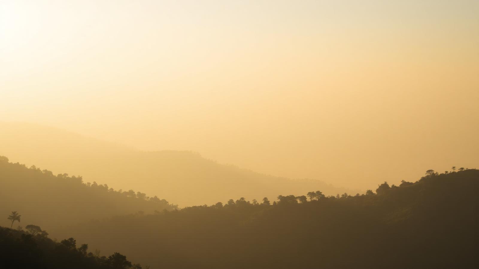 Misty Himalayan foothills at sunrise